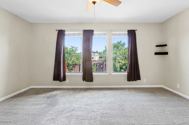 Spare room with plenty of natural light, carpet flooring, and a ceiling fan | Image 19