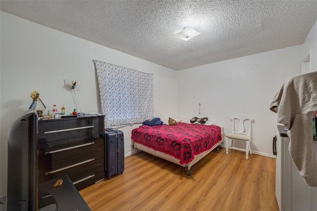 Unit A Bedroom with a textured ceiling and light hardwood / wood-style floors | Image 30