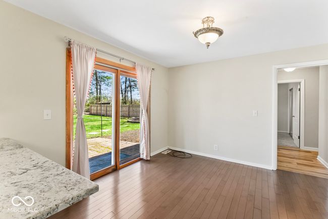 dining space featuring baseboards and dark wood-style floors | Image 13