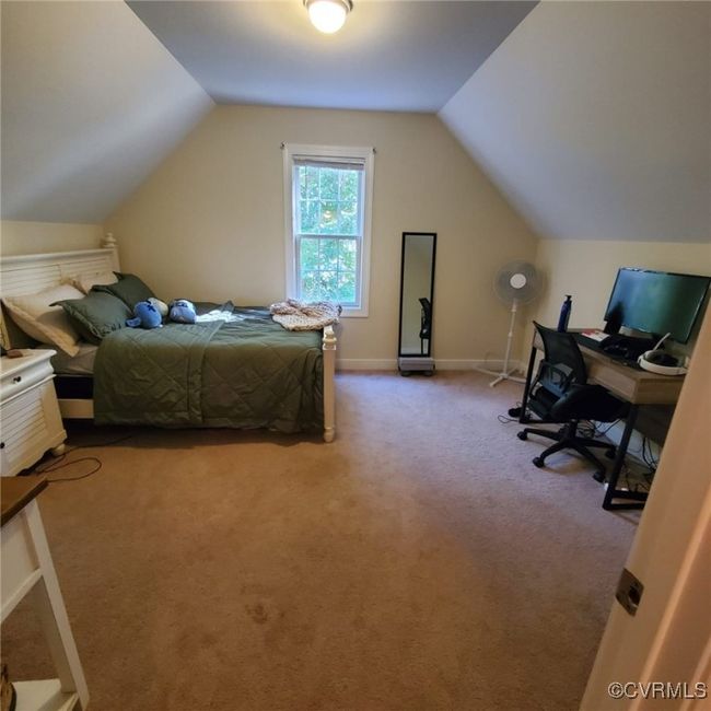 Carpeted bedroom featuring lofted ceiling and baseboards | Image 43