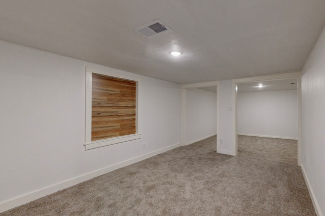 Basement with carpet flooring and a textured ceiling | Image 33