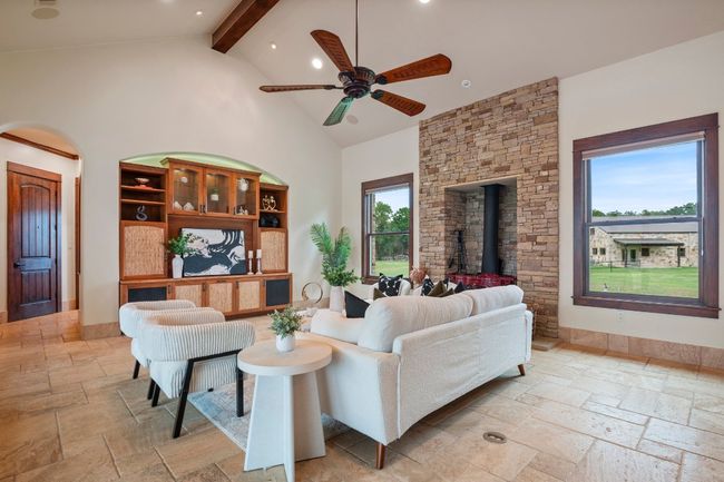 Living room with built in media center and shelves, stone fireplace/wood burning stove. | Image 12