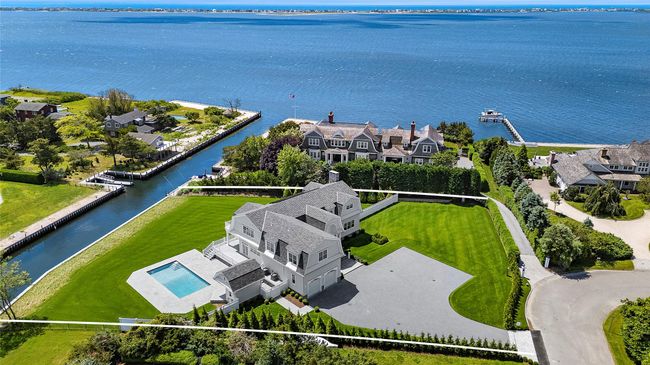 Aerial view of residential area with a nearby body of water and property boundaries highlighted | Image 4