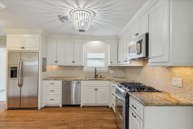 Fabulous kitchen with granite counters, designer backsplash, stainless appliances, and lots of counter space and cabinet storage. All appliances including refrigerator and washer and dryer. | Image 4