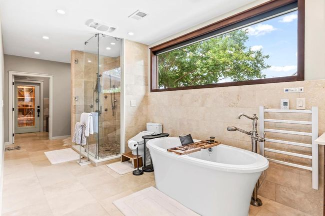 Full bath with tile walls, a soaking tub, a stall shower, and recessed lighting | Image 19