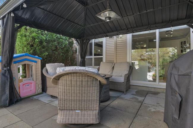 View of patio with a gazebo and an outdoor hangout area | Image 19