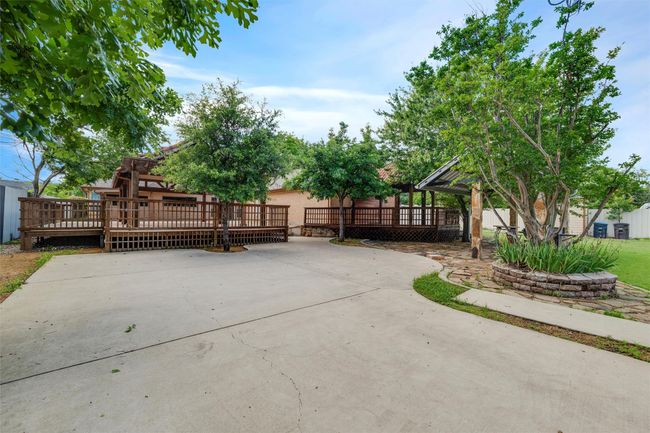 View of patio with a wooden deck | Image 25