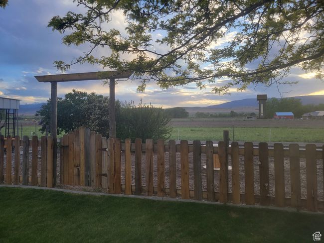 Yard at dusk with a mountain view and fence | Image 50
