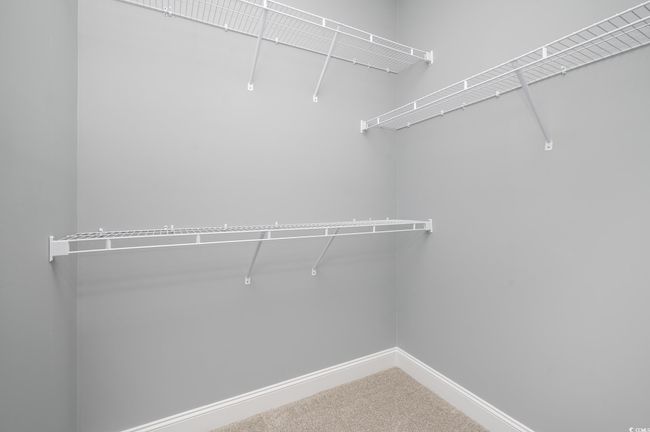Spacious closet with carpet floors | Image 18