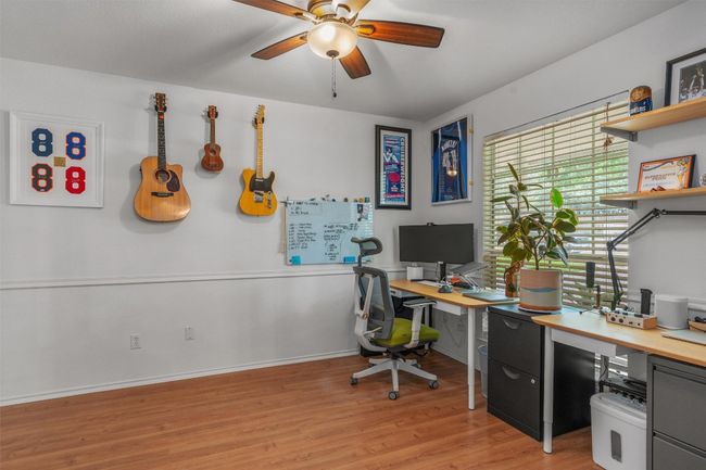 Home office featuring a ceiling fan and light wood-type flooring | Image 5