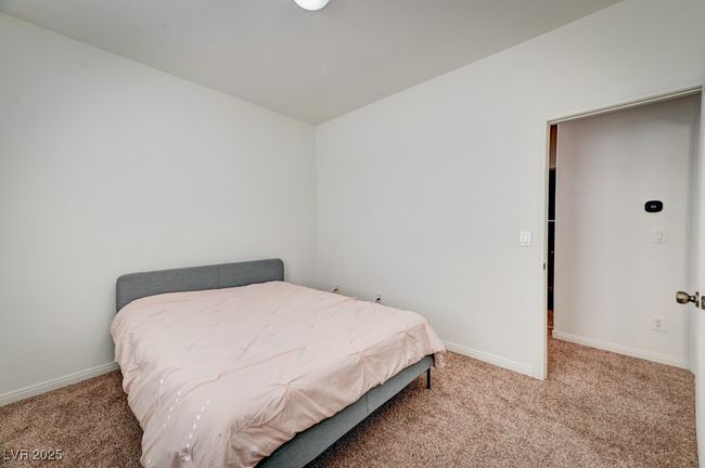 Carpeted bedroom with baseboards | Image 17