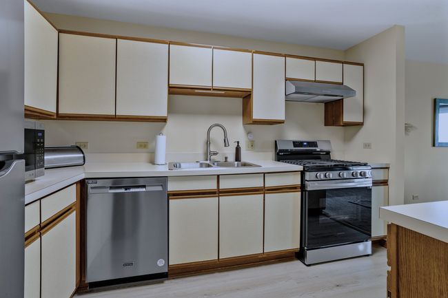 Kitchen with newer luxury vinyl flooring and light | Image 8