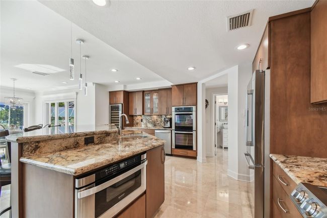 Open concept Kitchen Dining, entranceway into pool bath, laundry room | Image 32