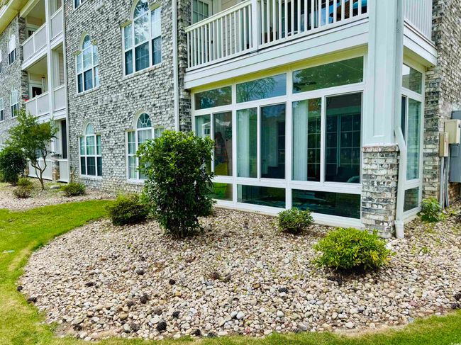 View of property exterior with stone siding and a balcony | Image 7