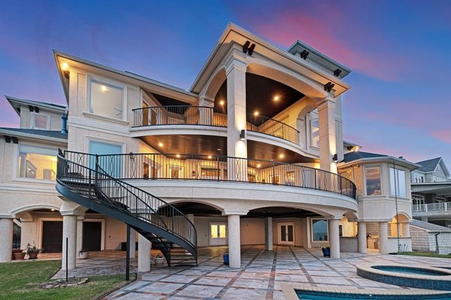 views of the rear of the home, note the balconies, circle staircase, and huge entertainment area | Image 7