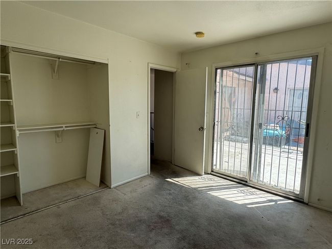 Unfurnished bedroom featuring carpet, a closet, and access to exterior | Image 7