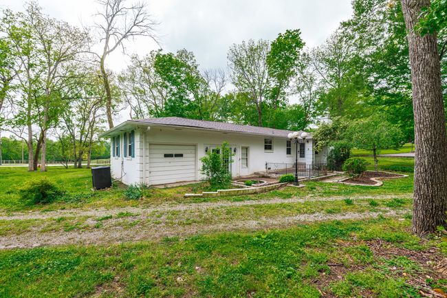 This home has a small storage garage for tools and outdoor equipment. A new roof installed in 2023 | Image 9