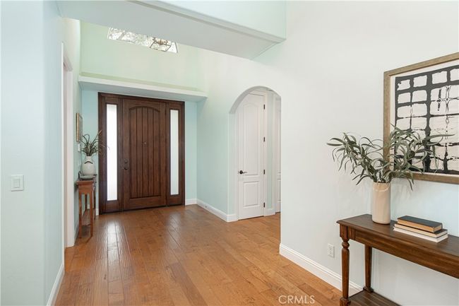 Front entry- to the left is the kitchen, to the right is the hallway to the office and bedrooms | Image 6