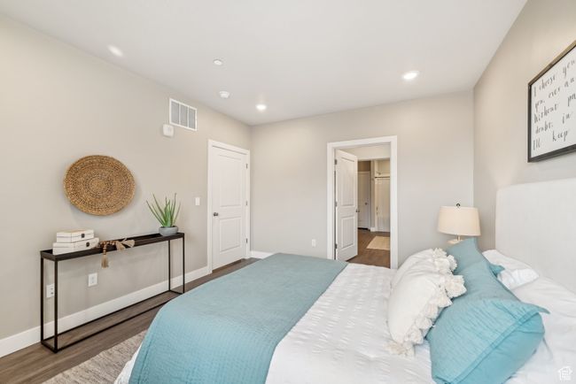 Bedroom featuring recessed lighting, wood finished floors, visible vents, and baseboards | Image 13