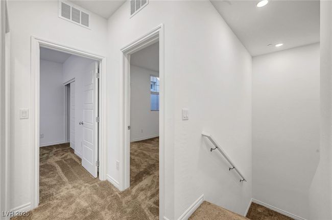 Hall featuring visible vents, an upstairs landing, and carpet flooring | Image 29