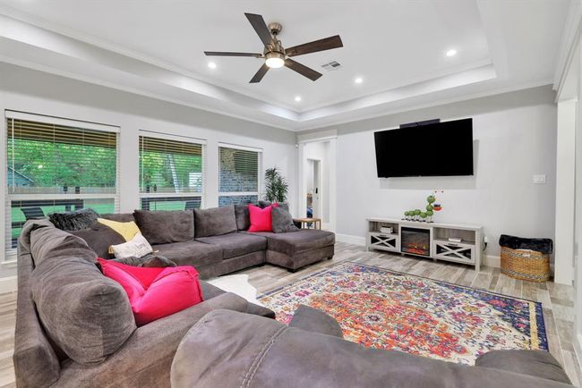 Sophisticated living space featuring gorgeous, oversized windows that invite the outdoors in. | Image 12