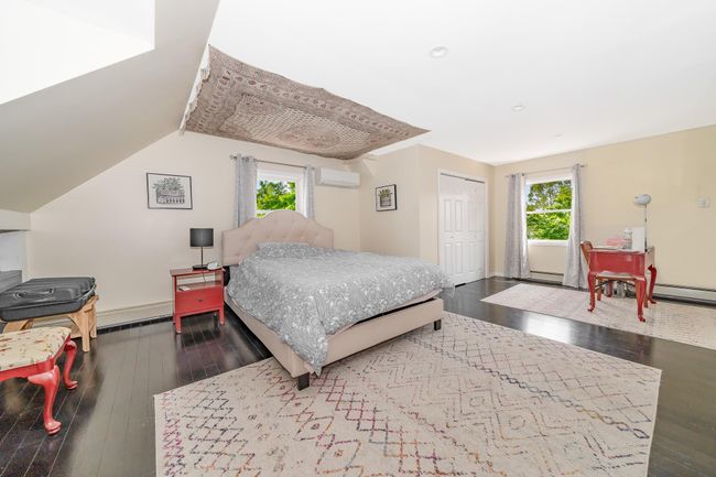 Bedroom with wood-type flooring, an AC wall unit, a closet, baseboards, and recessed lighting | Image 23