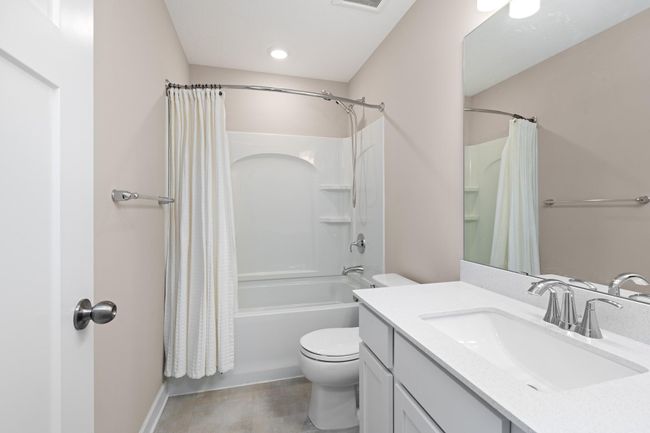This full bathroom supports the three secondary bedrooms found in the upper level. | Image 18