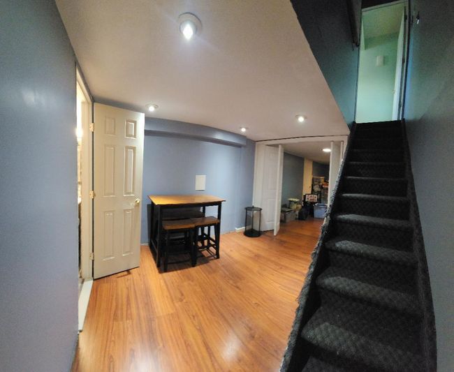 Stairway featuring wood finished floors | Image 9