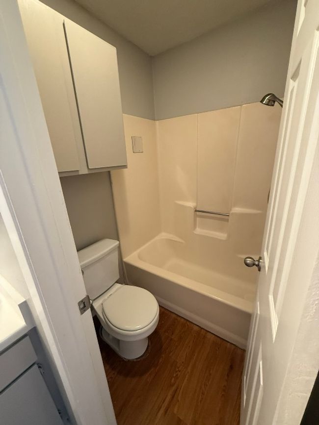 Full bathroom with wood finished floors, washtub / shower combination, and vanity | Image 20