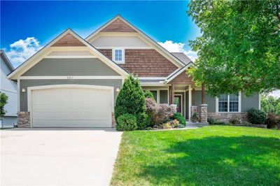 Rear view of property with a wooden deck, a yard, and a patio | Image 2