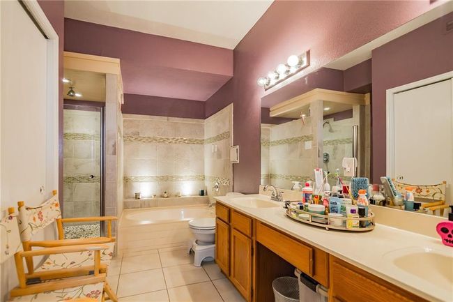 Full bathroom featuring tile patterned floors, a shower stall, a garden tub, and double vanity | Image 15
