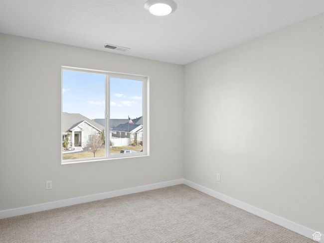 Spare room with carpet floors, visible vents, a textured ceiling, and baseboards | Image 19