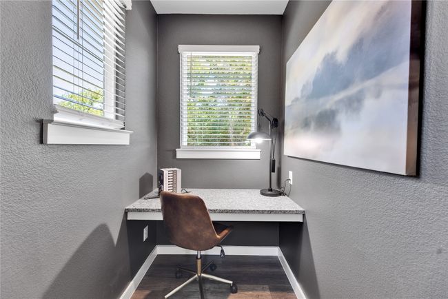 Office with a textured wall, baseboards, built in desk, and wood finished floors | Image 26