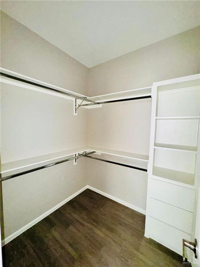 Spacious closet featuring dark wood-style floors | Image 19