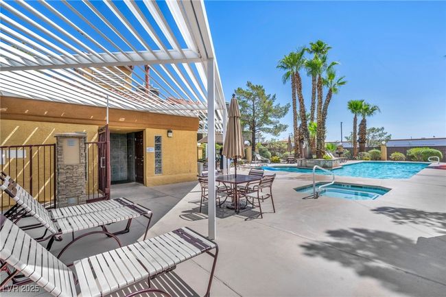 Pool featuring a hot tub and a patio area | Image 10