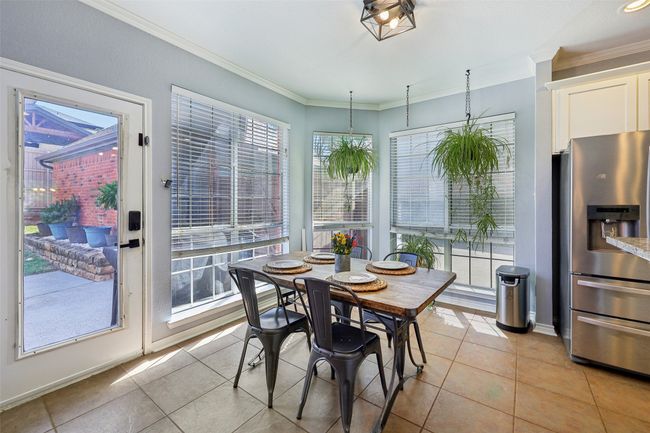 Bright and cheerful breakfast area overlooks the backyard and garage. | Image 13