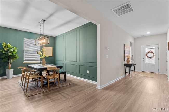 Dining space featuring light wood-type flooring, baseboards, recessed lighting, and a chandelier | Image 25