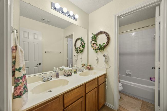 Full bath featuring double vanity and tub / shower combination | Image 25