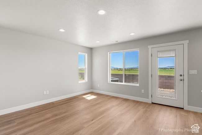 Unfurnished room featuring light wood finished floors, baseboards, and recessed lighting | Image 5