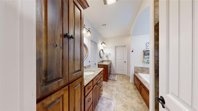 Bathroom featuring two vanities, a sink, and visible vents | Image 32