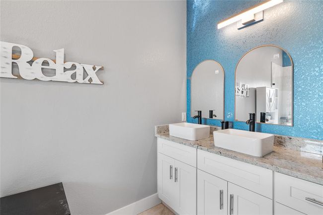 Elegant primary bathroom featuring stylish double sinks. | Image 11