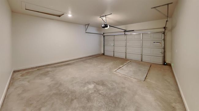 Garage featuring a garage door opener and baseboards | Image 18