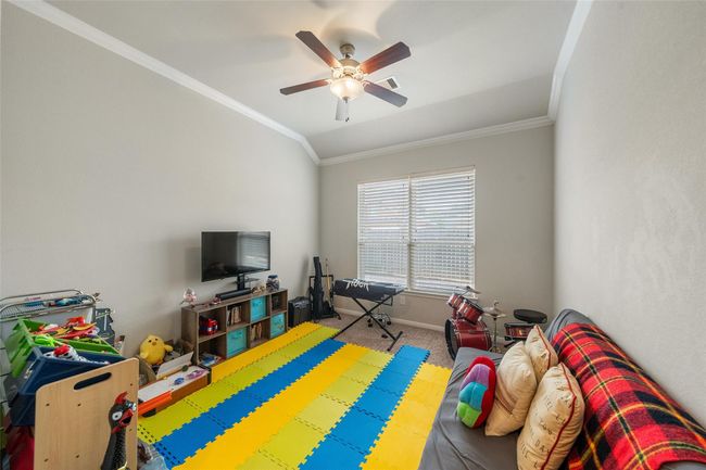Bright and inviting, this room is perfect as a play area or study, featuring a large window that floods the space with natural light. | Image 21