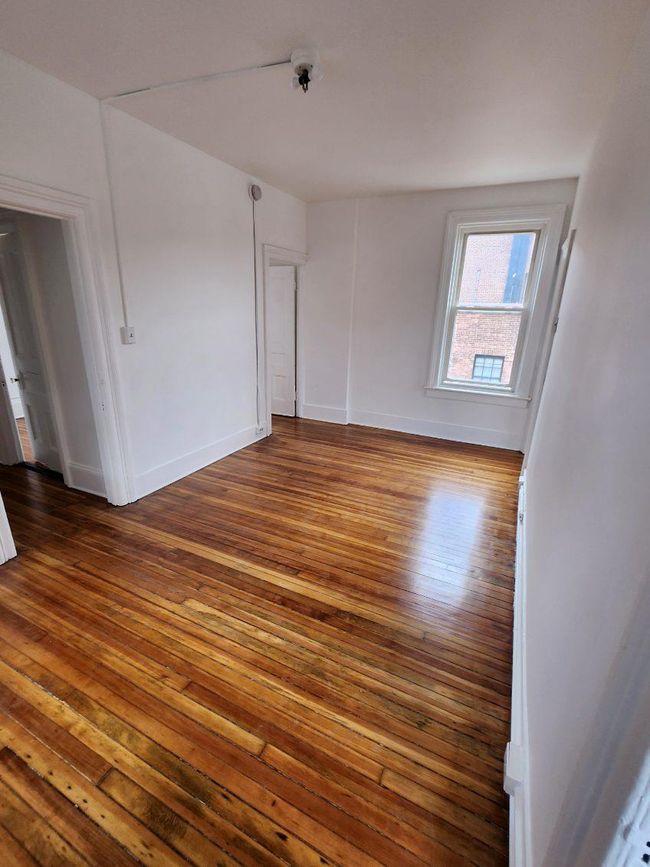 Unfurnished room with hardwood / wood-style floors and baseboards | Image 10