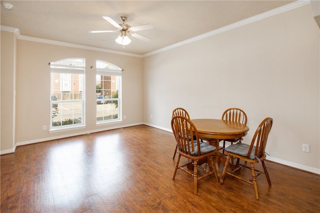 Dining area with wood finished floors, baseboards, and ornamental molding | Image 15