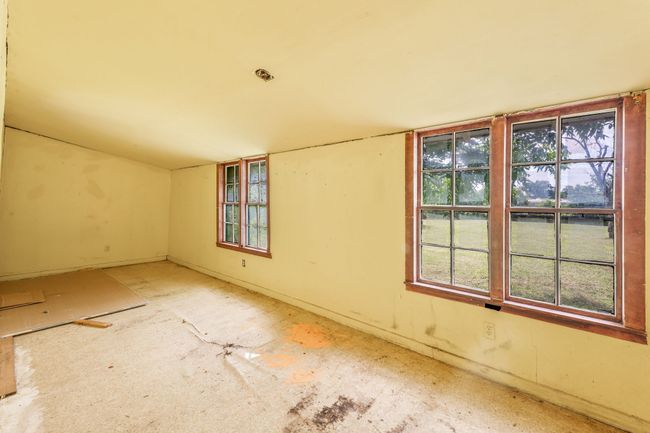 Empty room featuring healthy amount of natural light, baseboards, and fire sprinkler in ceiling | Image 13
