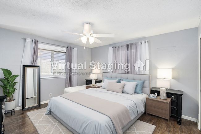 Bedroom with ceiling fan, baseboards, a textured ceiling, and wood finished floors | Image 19