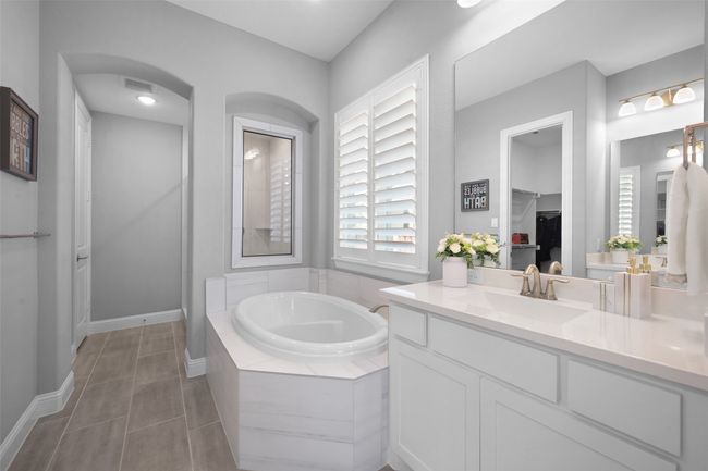 Primary Full Bathroom with double vanity, standing shower, and a garden tub. | Image 20