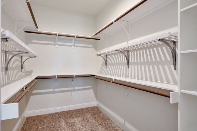 Spacious closet with carpet floors | Image 27