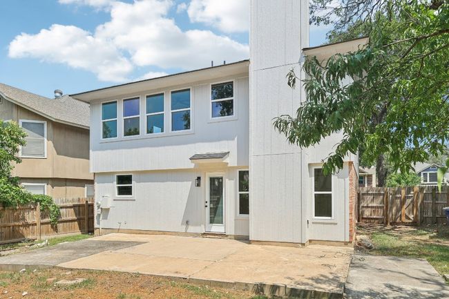 Rear view of house with a patio and a fenced backyard | Image 26